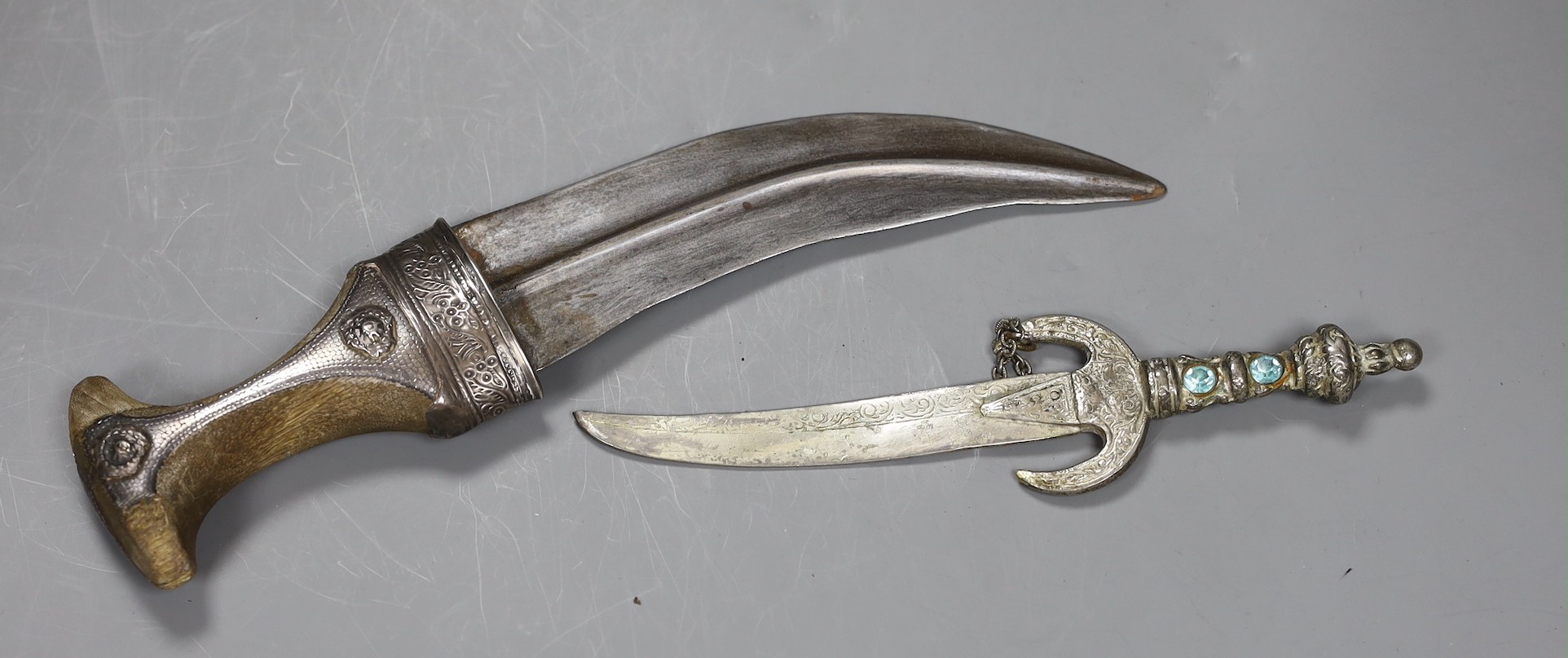 An Arab jambiya white metal dagger and one other ceremonial dagger